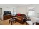 Comfortable living room features a leather sofa and natural lighting from two windows at 9 F St, Charleston, SC 29403