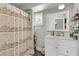 Cozy bathroom featuring a decorative shower curtain, and a white vanity with a large mirror at 10 Trapman St, Charleston, SC 29401