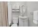 Bathroom with white fixtures, cabinet, and oval mirror for optimal lighting at 10 Trapman St, Charleston, SC 29401