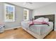 Bedroom with neutral colors, hardwood floors, and bright natural light coming through the windows at 10 Trapman St, Charleston, SC 29401