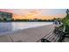 Scenic view of a lakeside park with benches and sunset with buildings in the background at 10 Trapman St, Charleston, SC 29401