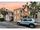 Quaint two-story house with a balcony and a car parked nearby, perfect for city living at 10 Trapman St, Charleston, SC 29401