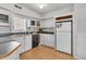 Functional kitchen features white cabinets, black appliances, and hardwood floors at 10 Trapman St, Charleston, SC 29401