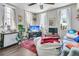 Bright living room with large windows, plants, and comfortable seating area at 10 Trapman St, Charleston, SC 29401