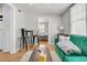 Living room featuring a green sofa with wood floors, a high-top table and view to bedroom at 10 Trapman St, Charleston, SC 29401