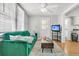 Bright living room featuring a green sofa, neutral rug, wood floors and a tv on a stand at 10 Trapman St, Charleston, SC 29401