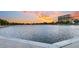 Picturesque waterfront view with an expansive lake and a building at sunset at 10 Trapman St, Charleston, SC 29401