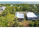 Captivating aerial view of modern home with metal roof surrounded by lush greenery and community at 1014 E Erie Ave, Folly Beach, SC 29439