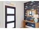 Stylish entryway with a modern door, unique wallpaper, and decorative mirror adding character at 1014 E Erie Ave, Folly Beach, SC 29439