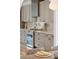 Gourmet kitchen with light gray cabinetry, stainless steel appliances, and a stylish backsplash at 1014 E Erie Ave, Folly Beach, SC 29439