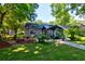 Relaxing backyard features a covered patio, lush landscaping, and charming outdoor seating area at 102 Cottonwood Dr, Summerville, SC 29483