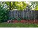 Fenced backyard with beautiful landscaping, plants, and rock border at 102 Cottonwood Dr, Summerville, SC 29483