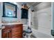 Cozy bathroom features a shower-tub combination and vanity with a decorative mirror and storage shelves at 102 Cottonwood Dr, Summerville, SC 29483