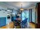 Dining room with wood floors that connects kitchen to outside screened in patio at 102 Cottonwood Dr, Summerville, SC 29483