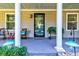 Charming front porch features elegant columns, lovely decor, and outdoor seating creating a welcoming entrance at 102 Cottonwood Dr, Summerville, SC 29483