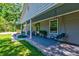 Long front porch with a swing, columns and decorative landscaping enhances the curb appeal at 102 Cottonwood Dr, Summerville, SC 29483