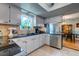 Well lit kitchen with stainless steel dishwasher and white cabinets at 102 Cottonwood Dr, Summerville, SC 29483