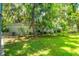 Private backyard offering ample space surrounded by mature trees and a fence at 104 Queens Ct, Summerville, SC 29485