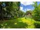 Spacious backyard featuring green grass, mature trees, and a fence at 104 Queens Ct, Summerville, SC 29485