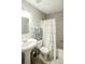 Cozy bathroom featuring a pedestal sink, fresh white shower curtain, and classic tile flooring at 104 Queens Ct, Summerville, SC 29485