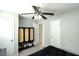 View of a bedroom with a ceiling fan, closet, and a unique cabinet featuring caning details and open shoe shelving at 104 Queens Ct, Summerville, SC 29485