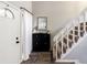 Welcoming entryway with white door, staircase, and accent mirror at 104 Queens Ct, Summerville, SC 29485