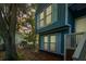 Charming blue two-story home featuring light blue shutters and mature landscaping at 104 Queens Ct, Summerville, SC 29485