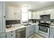 Stylish kitchen featuring stainless steel appliances, granite countertops, and two-tone cabinetry at 104 Queens Ct, Summerville, SC 29485