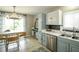 Inviting kitchen with gray and white cabinets, stainless steel appliances, and dining area at 104 Queens Ct, Summerville, SC 29485