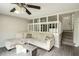 Inviting living room featuring a comfortable sectional sofa and stylish decor, illuminated by a modern ceiling fan at 104 Queens Ct, Summerville, SC 29485