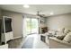 Spacious living room with ceiling fan, sliding glass doors, and neutral decor at 104 Queens Ct, Summerville, SC 29485