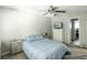 Serene bedroom with a cozy blue comforter, neutral walls, and matching nightstands, ceiling fan at 104 Queens Ct, Summerville, SC 29485