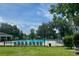 Community pool with ample seating and lush landscaping, perfect for outdoor recreation and relaxation at 104 Queens Ct, Summerville, SC 29485
