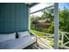 View from the covered porch showing white railings, a white cushioned lounge, and a fenced-in yard at 104 Queens Ct, Summerville, SC 29485