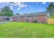 Backyard with a brick house and a grassy lawn at 108 Reardon St, Moncks Corner, SC 29461