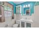 This bathroom has a vanity with a mirror, cabinet, toilet, and window at 108 Reardon St, Moncks Corner, SC 29461