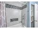 Bathroom featuring shower/tub combo with decorative tile and convenient shelving at 108 Reardon St, Moncks Corner, SC 29461