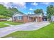 Brick home featuring a carport and well-maintained lawn with a lovely landscape at 108 Reardon St, Moncks Corner, SC 29461