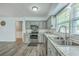 Stainless steel appliances and light grey cabinets highlight this well lit eat-in kitchen space at 108 Reardon St, Moncks Corner, SC 29461