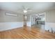 Open-concept living room with hardwood floors that flows into the adjacent kitchen at 108 Reardon St, Moncks Corner, SC 29461
