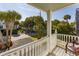 Inviting balcony view overlooking a charming street lined with lush palm trees, offering a serene and tropical ambiance at 109 Carolina Blvd, Isle of Palms, SC 29451