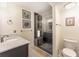 Well-lit bathroom featuring a tiled shower with a glass door and a modern vanity at 109 Carolina Blvd, Isle of Palms, SC 29451