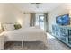 Inviting bedroom with balcony access, a blue cabinet with a TV, and neutral walls at 109 Carolina Blvd, Isle of Palms, SC 29451