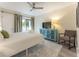 Cozy bedroom boasts a ceiling fan, balcony access, and a blue cabinet with a TV at 109 Carolina Blvd, Isle of Palms, SC 29451