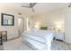 Light bedroom with white iron bed frame, ceiling fan, and access to other areas of the house at 109 Carolina Blvd, Isle of Palms, SC 29451