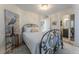 Comfortable bedroom featuring a decorative iron bed frame, chandelier, and ensuite bathroom access at 109 Carolina Blvd, Isle of Palms, SC 29451