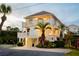 Elegant two-story coastal home with charming balconies, lush landscaping, and a well-manicured yard, perfect for tranquil living at 109 Carolina Blvd, Isle of Palms, SC 29451