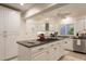 Bright kitchen features granite countertops, stainless steel appliances, and a center island cooktop at 109 Carolina Blvd, Isle of Palms, SC 29451