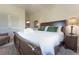 Comfortable main bedroom with king bed, nightstands and lamp, chair, and white linen closet at 109 Carolina Blvd, Isle of Palms, SC 29451