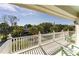 Comfortable outdoor porch with railings, palm trees, and seating area at 109 Carolina Blvd, Isle of Palms, SC 29451
